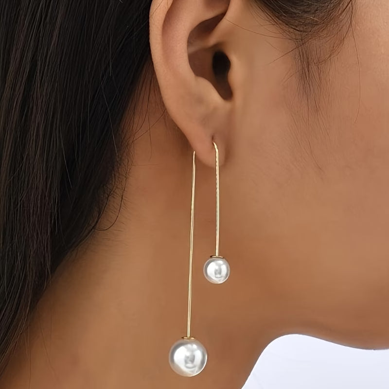Statement oorbellen met stralende parel